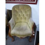 A Victorian mahogany buttonback armchair, having scroll decoration