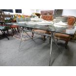 A vintage Heal's style chrome dining table with oblong glass top