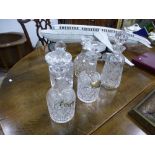 Five various decanters, two having silver wine labels
