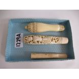 Oriental carved ivory handle decorated with figures, an ivory cheroot holder