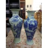 Two similar modern Chinese baluster vases decorated buildings in landscapes, the largest 95.5cms