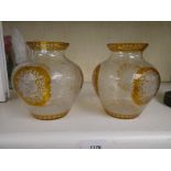 A pair of Bohemian amber and clear glass vases, decorated flowers