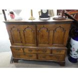 An 18th century style oak cupboard having pair of panelled doors with five drawers below, 139cms