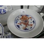 A Chinese blue and white dish decorated red dragons, 20 cms