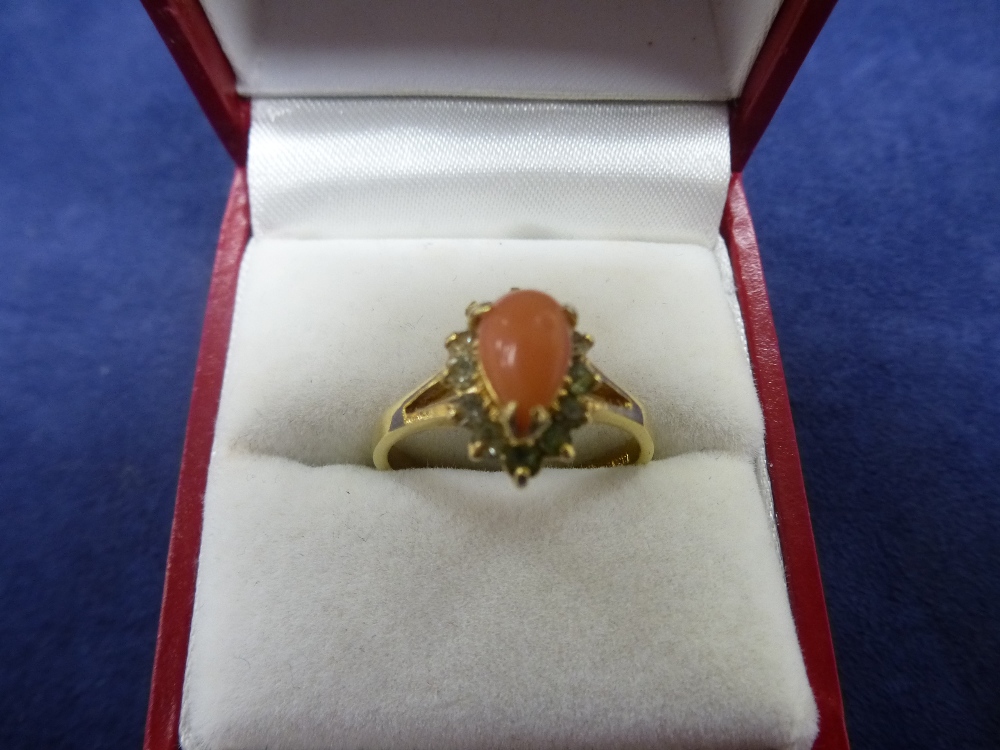 18K yellow gold dress ring set with tear shaped coral stone and surrounded by clear stones, size P/Q