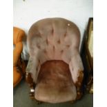 A Victorian walnut buttonback armchair, having scroll decoration