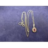 Hallmarked 18ct gold, diamond and ruby pendant on white metal chain - rubbed mark