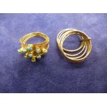 Yellow coloured metal multi ring set together with another yellow coloured metal ring set with