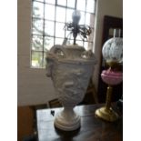 An antique style plaster lamp in the form of an urn with ramshead handles, body height 53 cms