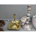 A small silver towel dish, a brass chamberstick and a silver plated candlestick