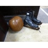 An old leather medicine ball and a pair of ice skates