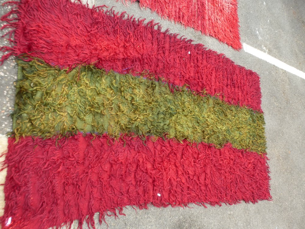 A Turkish Tulu rug having green central stripe and one other red Tulu rug, the largest, 224 x 130cms