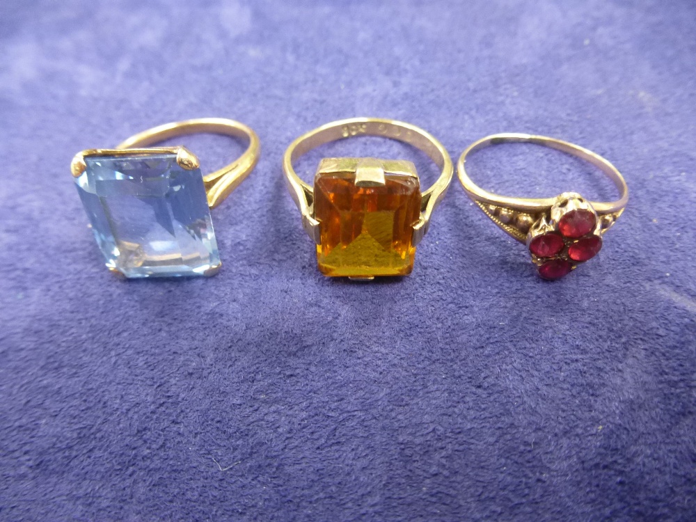 Two 9ct gold dress rings set with a blue and yellow stone and unmarked yellow coloured metal dress