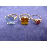 Two 9ct gold dress rings set with a blue and yellow stone and unmarked yellow coloured metal dress