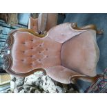 A similar Victorian mahogany buttonback armchair having carved back