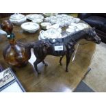 A leather covered horse and a similar decanter