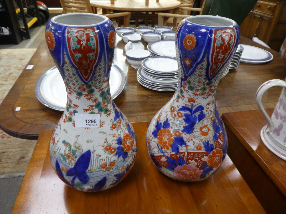 A pair of Japanese floral vases - one damaged - 29.5cms