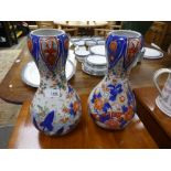 A pair of Japanese floral vases - one damaged - 29.5cms