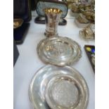 A Continental silver beaker marked 800 weight 5.28 oz and three white metal plates/dishes of Eastern