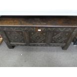 An antique oak coffer having carved panelled front, 124 cms