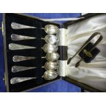 A cased set of teaspoons and a pair of sugar tongs, each bowl decorated with a different embossed