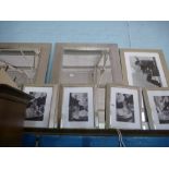 A pair of bevelled framed wall mirrors and several decorative prints