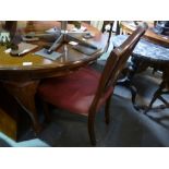 A set of eight antique Hepplewhite style mahogany shield back dining chairs on square tapered legs