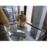 Bronzed figure of a jockey on a marble plinth