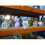 Shelf of novelty ceramic teapots incl. Wade, Carltonware examples and an unusual clown design teapot