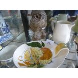 A Poole pottery owl with a Newport pottery jug marked Clarice Cliff and a plate by Staffordshire