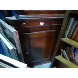 An oak hanging corner cupboard