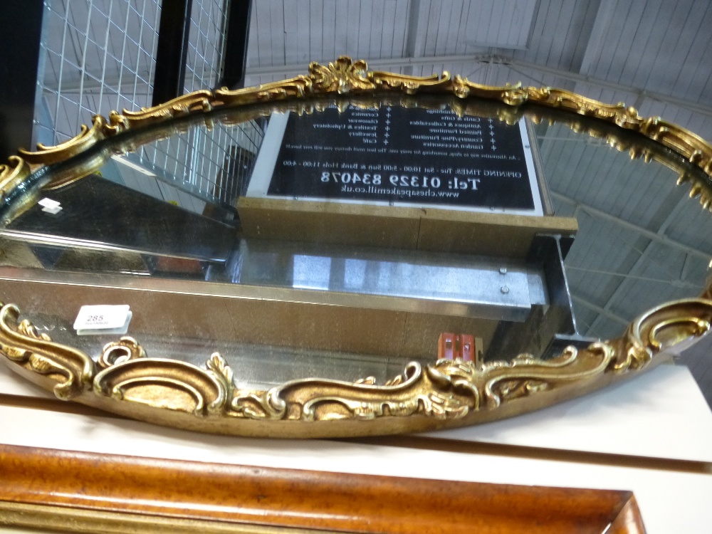 Large oval gilt framed mirror