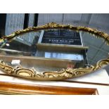 Large oval gilt framed mirror