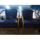 Pair of bamboo framed blue seat and back armchairs and larger example