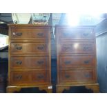 A pair of reproduction Yew bedside chests each having four drawers