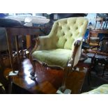 A Victorian mahogany button back armchair, having scroll decoration