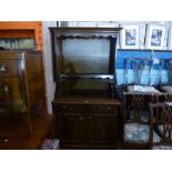 Mahogany and oak dresser with open rack above drawers and cupboards