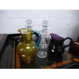 A collection of vintage glass ware comprising of 3 decanters and two jugs, glasses etc.