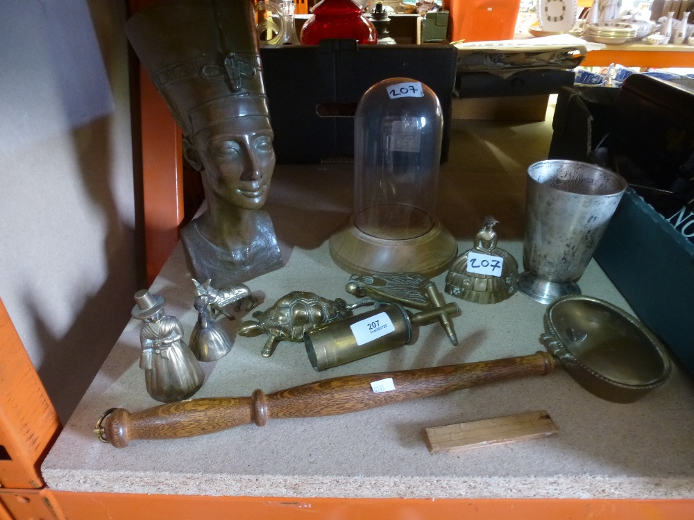 A selection of brassware including bells and a resin head