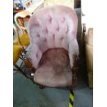 A Victorian walnut buttonback armchair, having scroll decoration