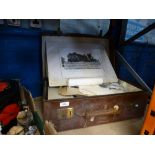 A vintage suitcase containing old black and white photographs