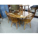 An oak oval pedestal table and six hoop back chairs with crinoline stretches of 18th Style