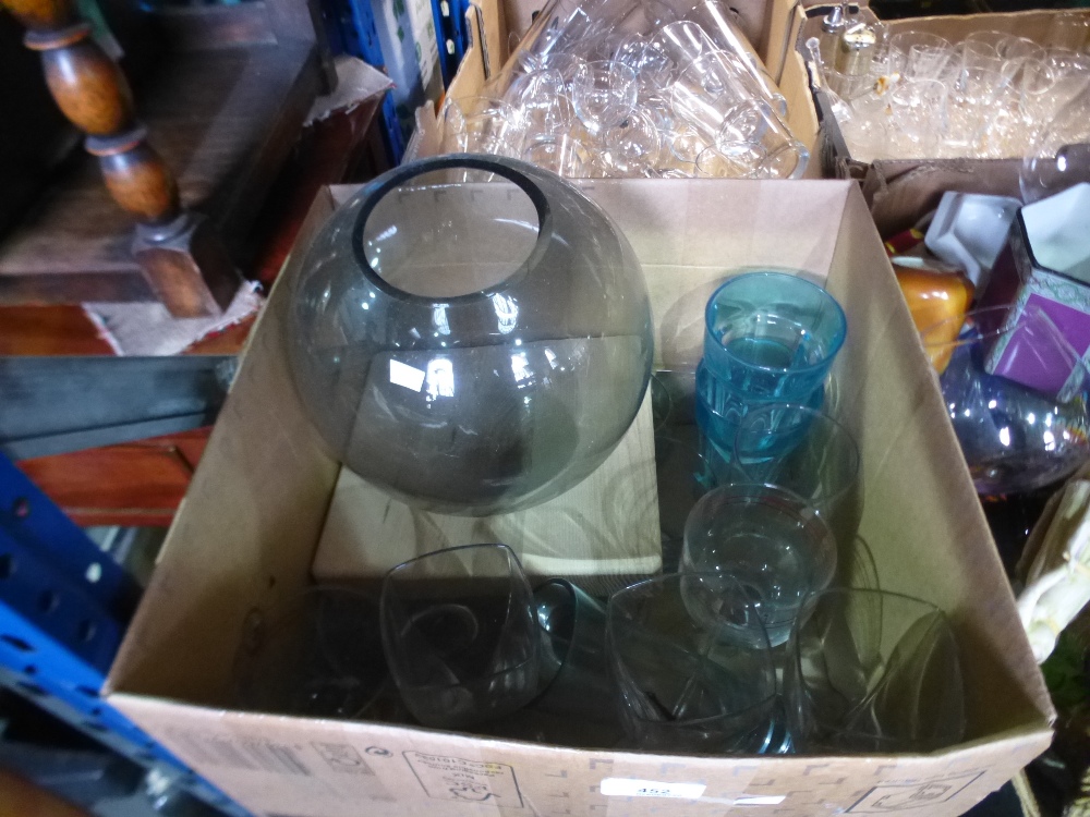 Box of drinking glasses and glass vase on wooden plinth