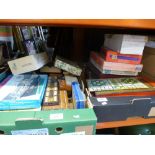 Two boxes containing playing cards, jigsaws and a variety of old games, etc