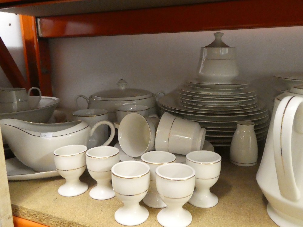 A quantity of white with gold banding dinner ware to include plates, bowls, serving dish, gravy jug,