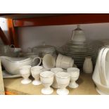 A quantity of white with gold banding dinner ware to include plates, bowls, serving dish, gravy jug,