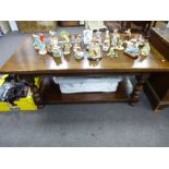 An oak coffee table with turned supports and an under tray oak base by Tichmarsh and Goodwin