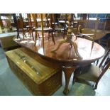 An early 20th century mahogany oval dining extending table having two leaves on cabriole legs,