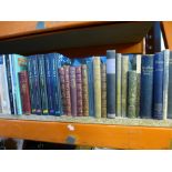 A shelf of mostly hardback books to include Charles Dickens, Tennyson, R.L. Stevenson, etc