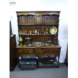 An 19th Century style oak three draw pot board dresser with rack on turned legs by Tichmarsh and